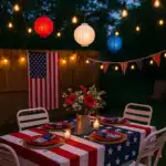 Patriotic backyard setup with string lights, red, white, and blue lanterns, and a star-spangled table for 4th of July celebration.