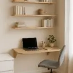Small home office with pastel walls and vertical storage units