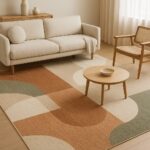 A featured image of a modern living room showcasing a large geometric rug in earthy tones of beige, terracotta, and sage green, with minimalist furniture, soft lighting, and natural wooden flooring.